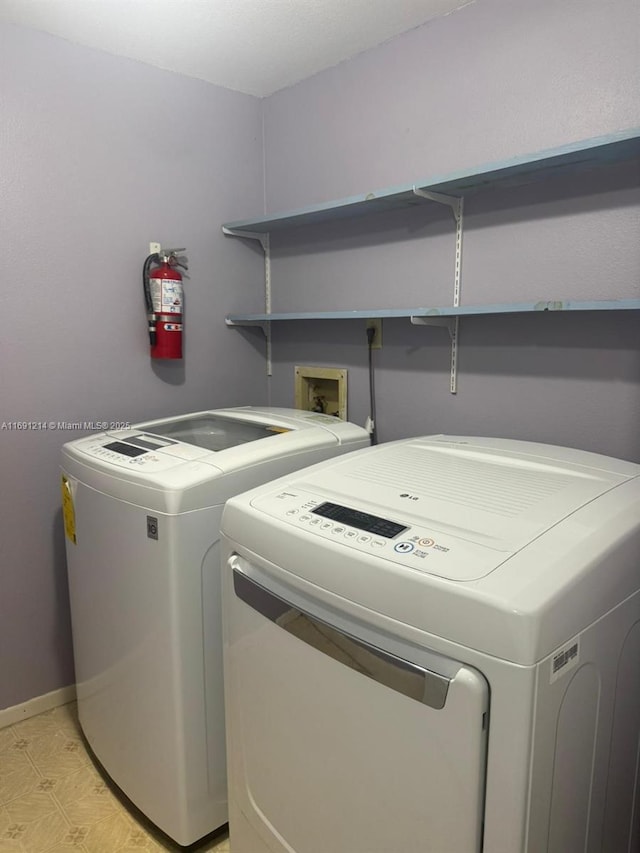 clothes washing area featuring washer and clothes dryer