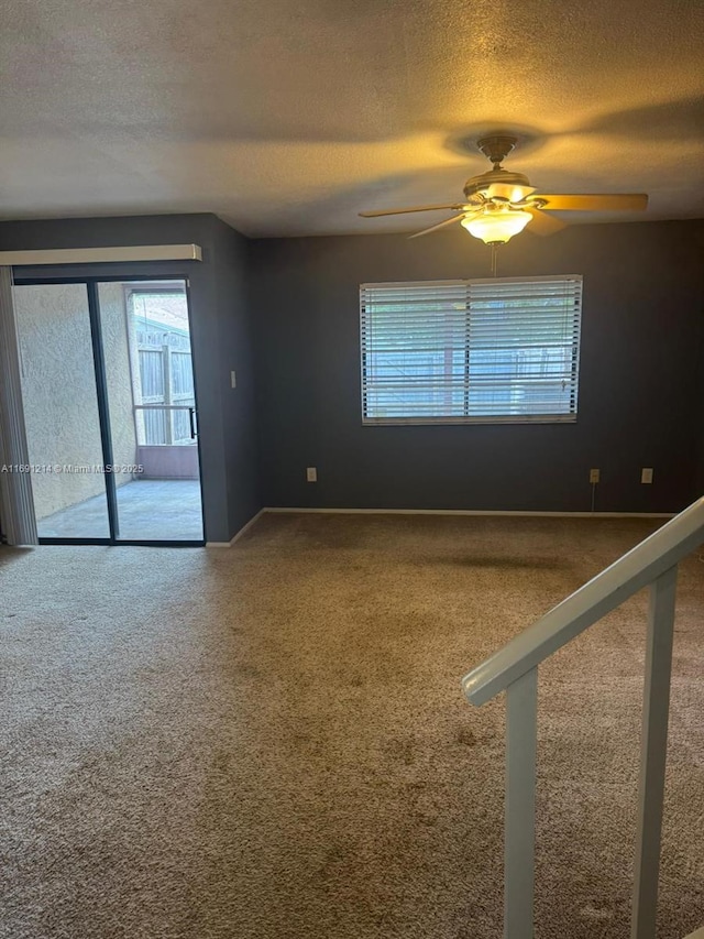 empty room featuring ceiling fan and a textured ceiling