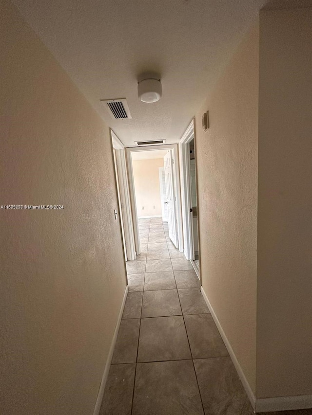 corridor with tile patterned floors