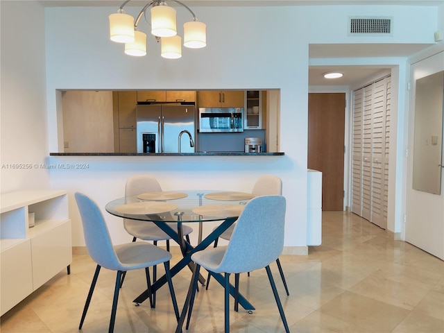 dining space with an inviting chandelier