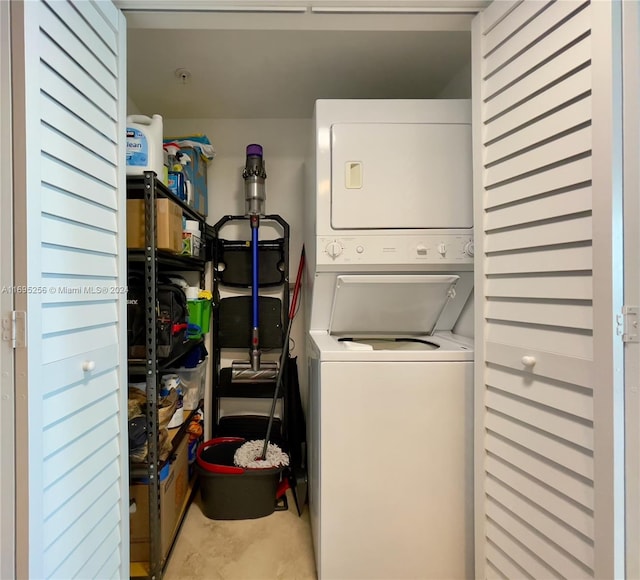 washroom with stacked washer / drying machine