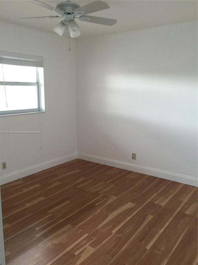 spare room with ceiling fan and dark hardwood / wood-style flooring