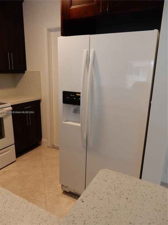 5051 W Oakland Park Blvd Unit 302, Lauderdale Lakes, FL 33313 - kitchen with white appliances, light countertops, and light tile patterned floors