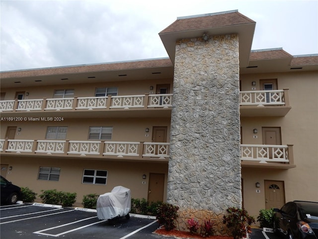 5051 W Oakland Park Blvd Unit 302, Lauderdale Lakes, FL 33313 - view of property featuring uncovered parking