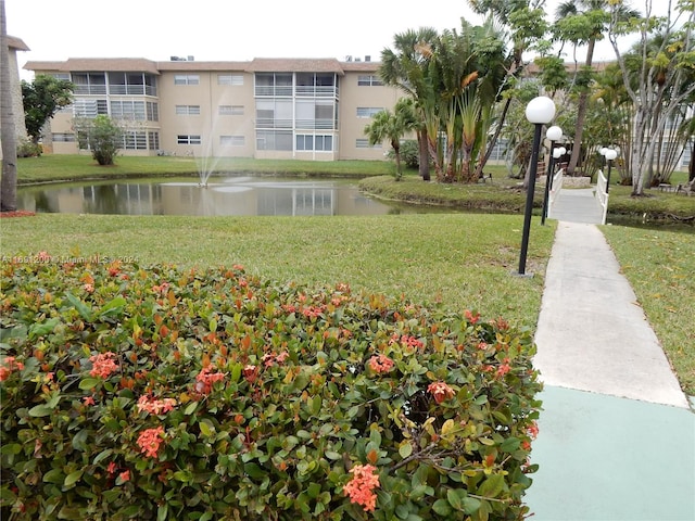 5051 W Oakland Park Blvd Unit 302, Lauderdale Lakes, FL 33313 - view of community with a water view and a yard
