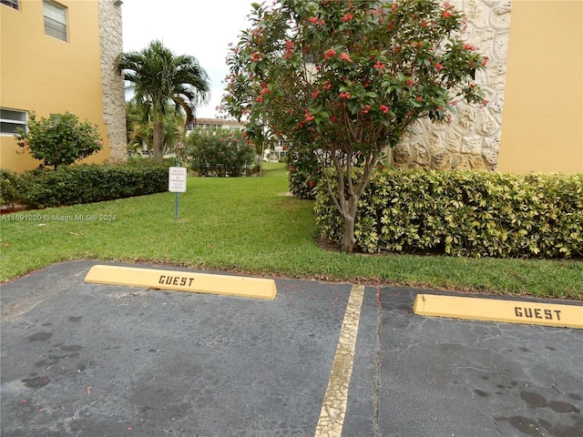 view of vehicle parking featuring a yard