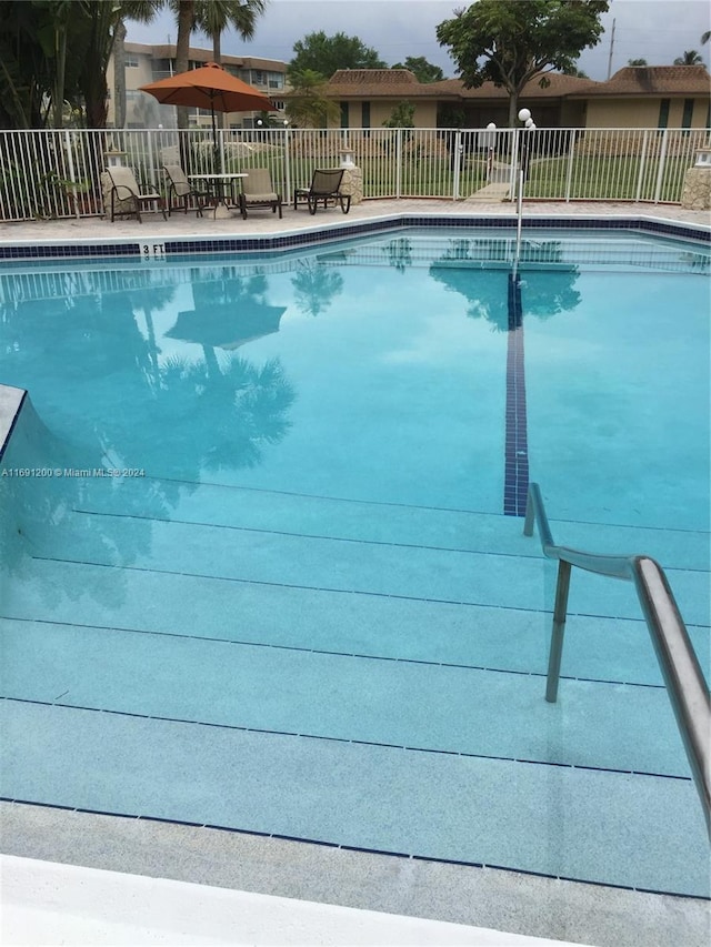 5051 W Oakland Park Blvd Unit 302, Lauderdale Lakes, FL 33313 - community pool featuring fence