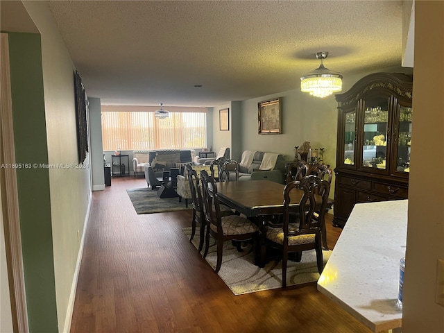 dining room featuring hardwood / wood-style floors and a textured ceiling