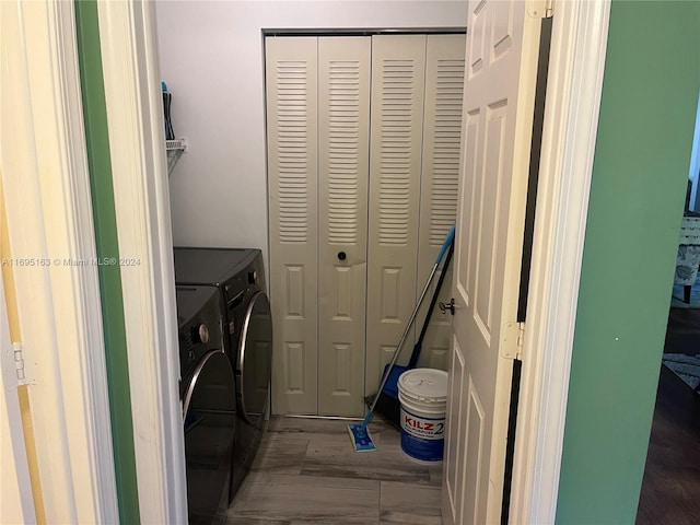 clothes washing area featuring independent washer and dryer and dark hardwood / wood-style floors