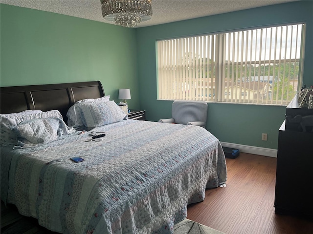 bedroom with hardwood / wood-style flooring and a textured ceiling