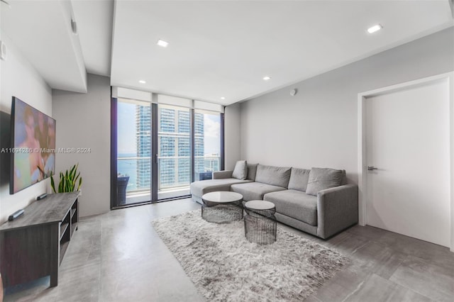 living room with floor to ceiling windows and concrete floors