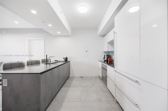 kitchen featuring white cabinets and sink