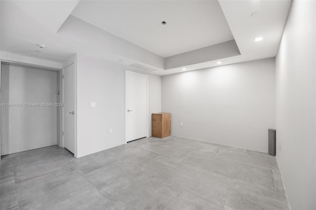 spare room featuring a tray ceiling