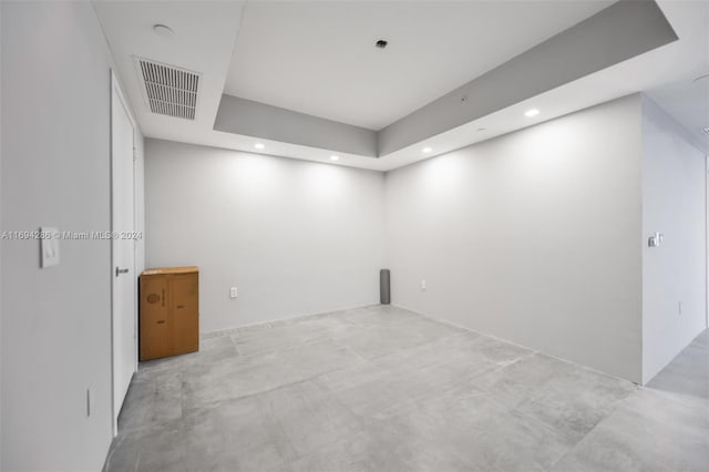 unfurnished room featuring a raised ceiling