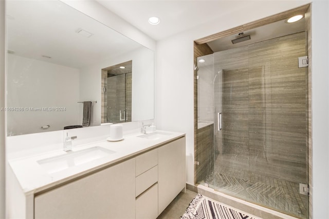 bathroom with a shower with door and vanity