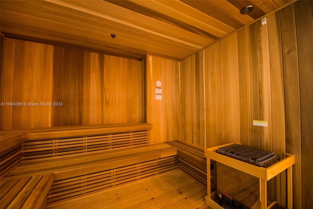 view of sauna / steam room featuring wood ceiling and wooden walls