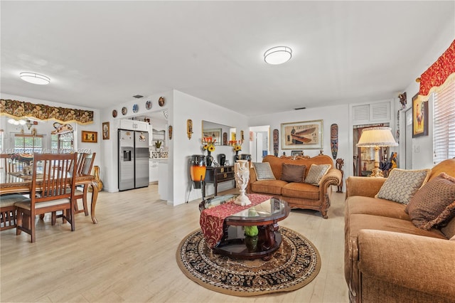 living room featuring light hardwood / wood-style flooring and a wealth of natural light