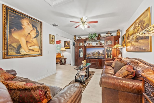 living room with ceiling fan and light wood-type flooring