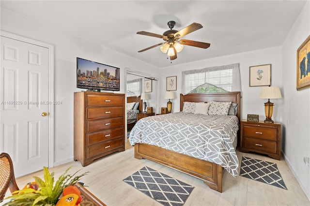 bedroom with light wood-type flooring, a closet, and ceiling fan