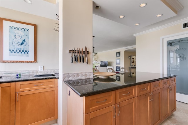 kitchen with dark stone countertops and light tile patterned flooring