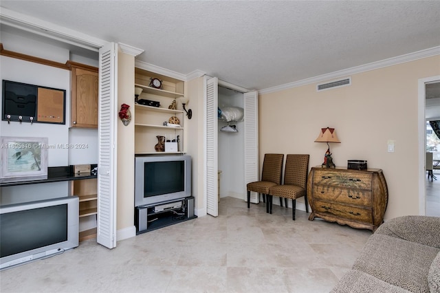 living area with crown molding and a textured ceiling