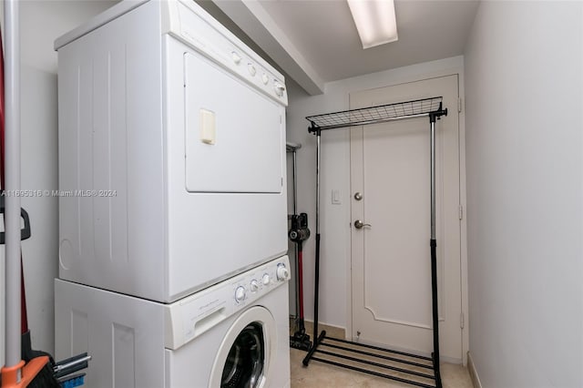 laundry room with stacked washer / dryer