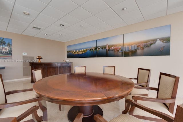 dining space with a paneled ceiling