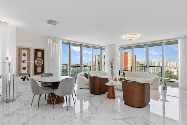 dining space with a healthy amount of sunlight, marble finish floor, expansive windows, and a city view