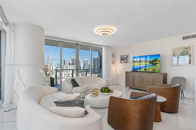 living area with expansive windows, marble finish floor, visible vents, and baseboards