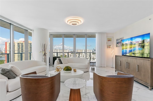 living area with a wealth of natural light, marble finish floor, and floor to ceiling windows