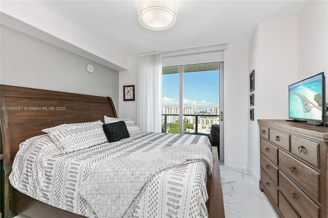 bedroom with baseboards, marble finish floor, and access to exterior