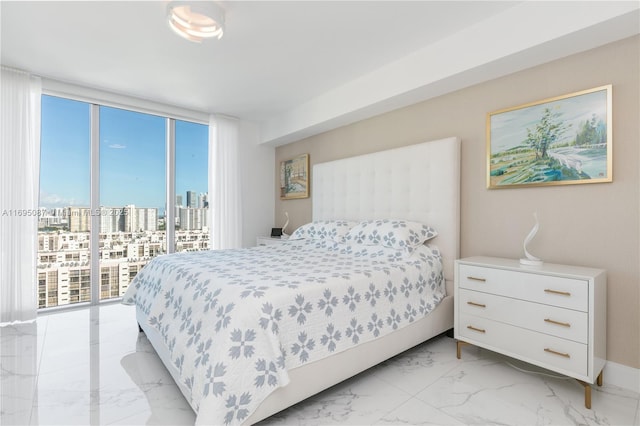 bedroom featuring a wall of windows, access to exterior, marble finish floor, and a city view