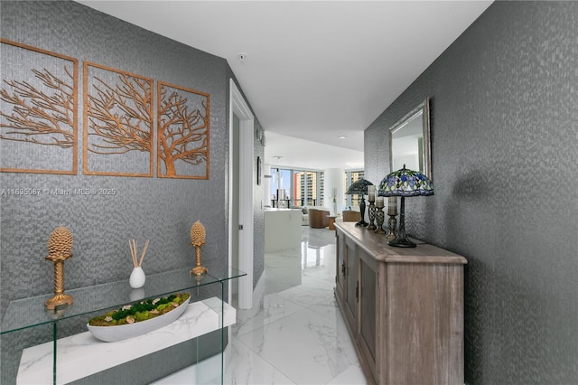 hallway featuring marble finish floor