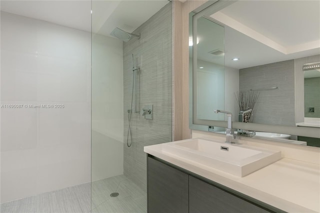 full bathroom featuring vanity, walk in shower, and visible vents