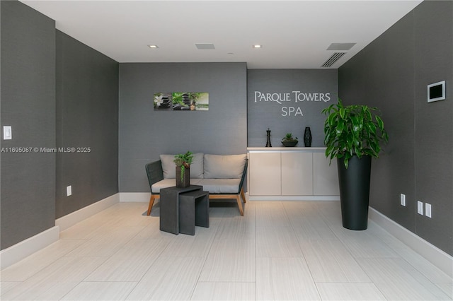 sitting room featuring visible vents and baseboards