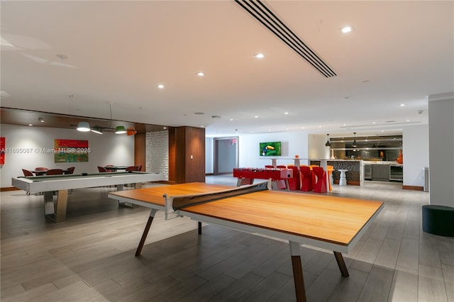 recreation room with wood finished floors and recessed lighting