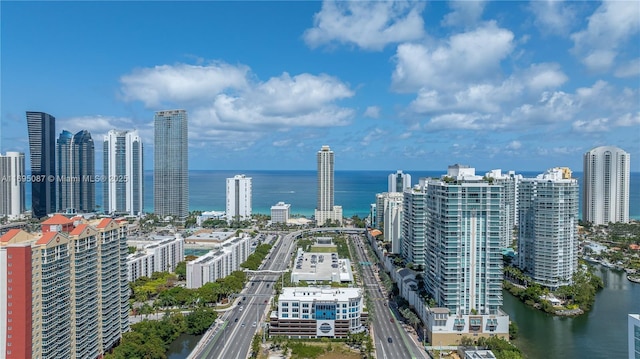 birds eye view of property with a water view and a view of city