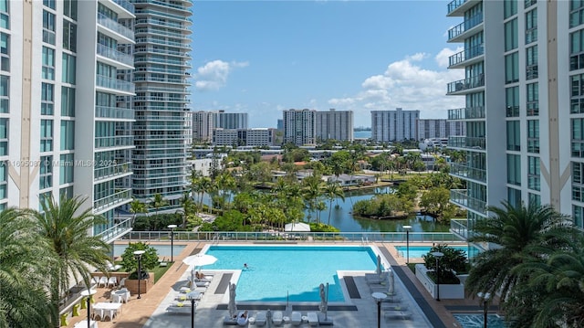 view of swimming pool with a water view and a view of city