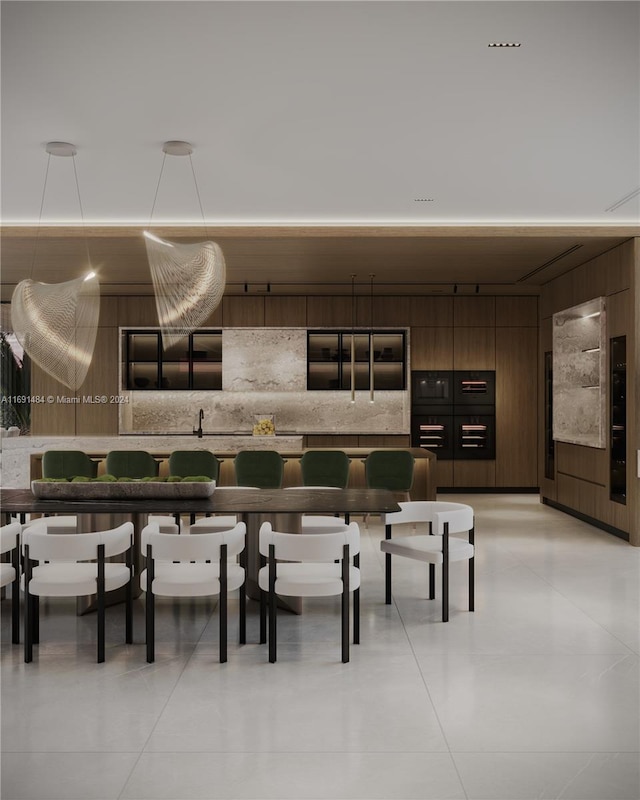 interior space featuring dark brown cabinetry, wood walls, and light tile patterned flooring