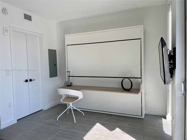 bathroom with tile patterned floors and electric panel