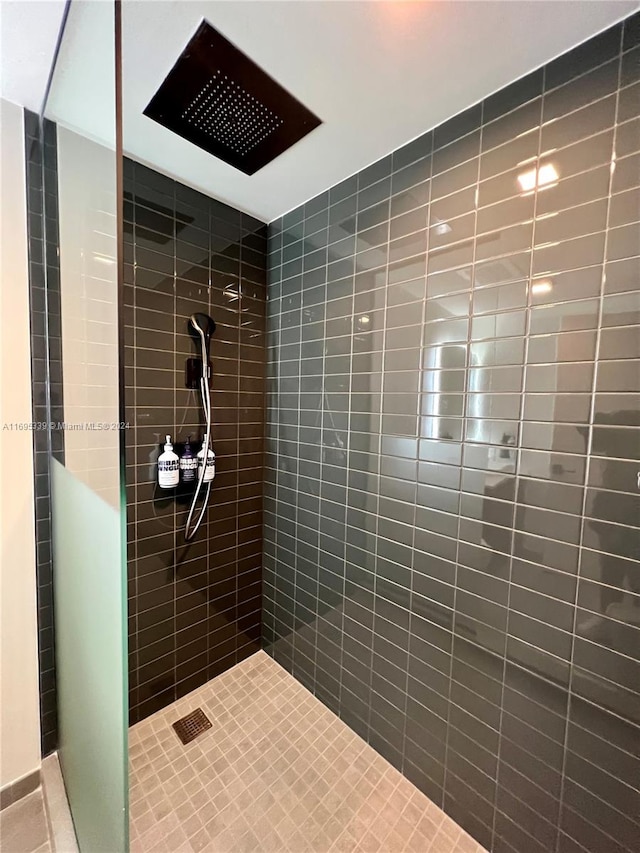 bathroom with a tile shower