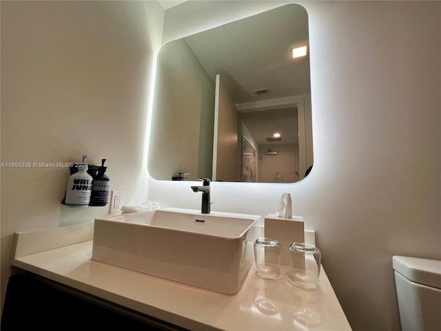 bathroom with vanity and toilet