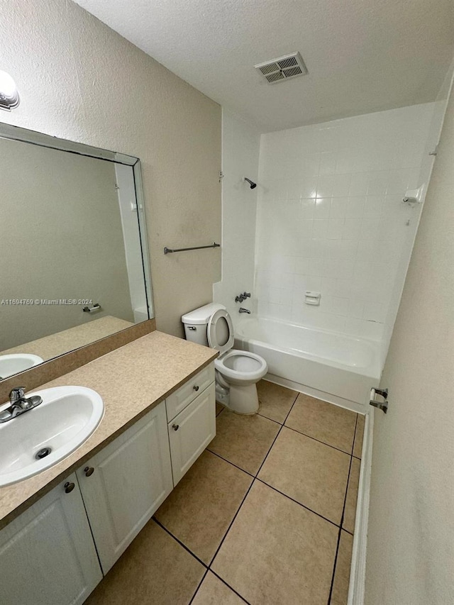 full bathroom featuring vanity, washtub / shower combination, tile patterned flooring, toilet, and a textured ceiling