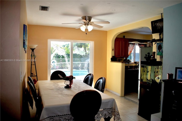 tiled dining room with ceiling fan