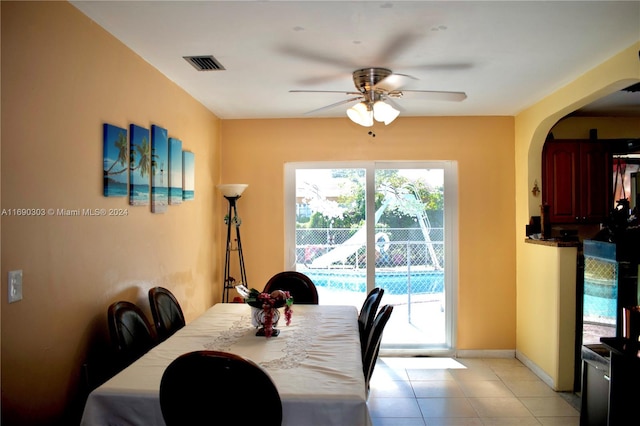 tiled dining area with ceiling fan