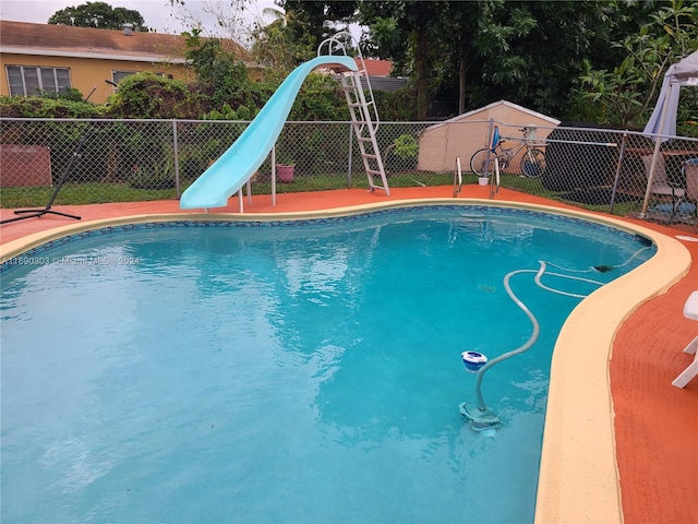 view of swimming pool with a water slide