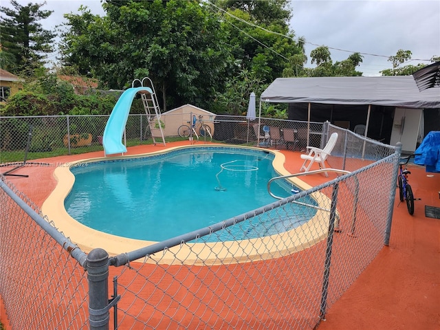 view of pool with a water slide