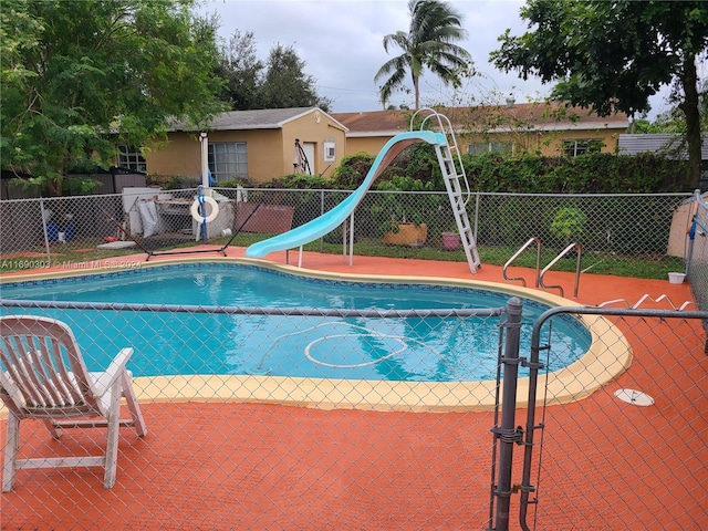 view of swimming pool featuring a water slide