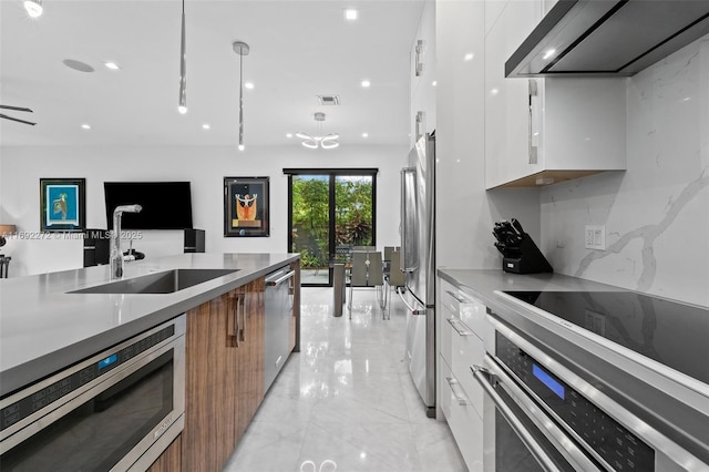 kitchen with modern cabinets, appliances with stainless steel finishes, and brown cabinetry