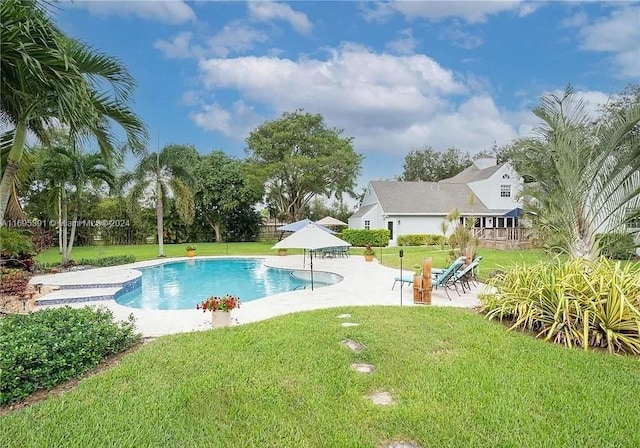 view of swimming pool with a lawn and a patio area